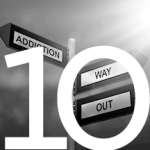#10 Street signs with one arrow saying "addiction" and the other arrow saying "way out"