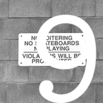 #9 sign on wall reading, "NO LOITERING"